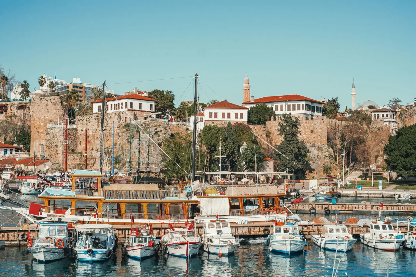 Old harbour of Antalya with fishing boats below the Kaleiçi walls